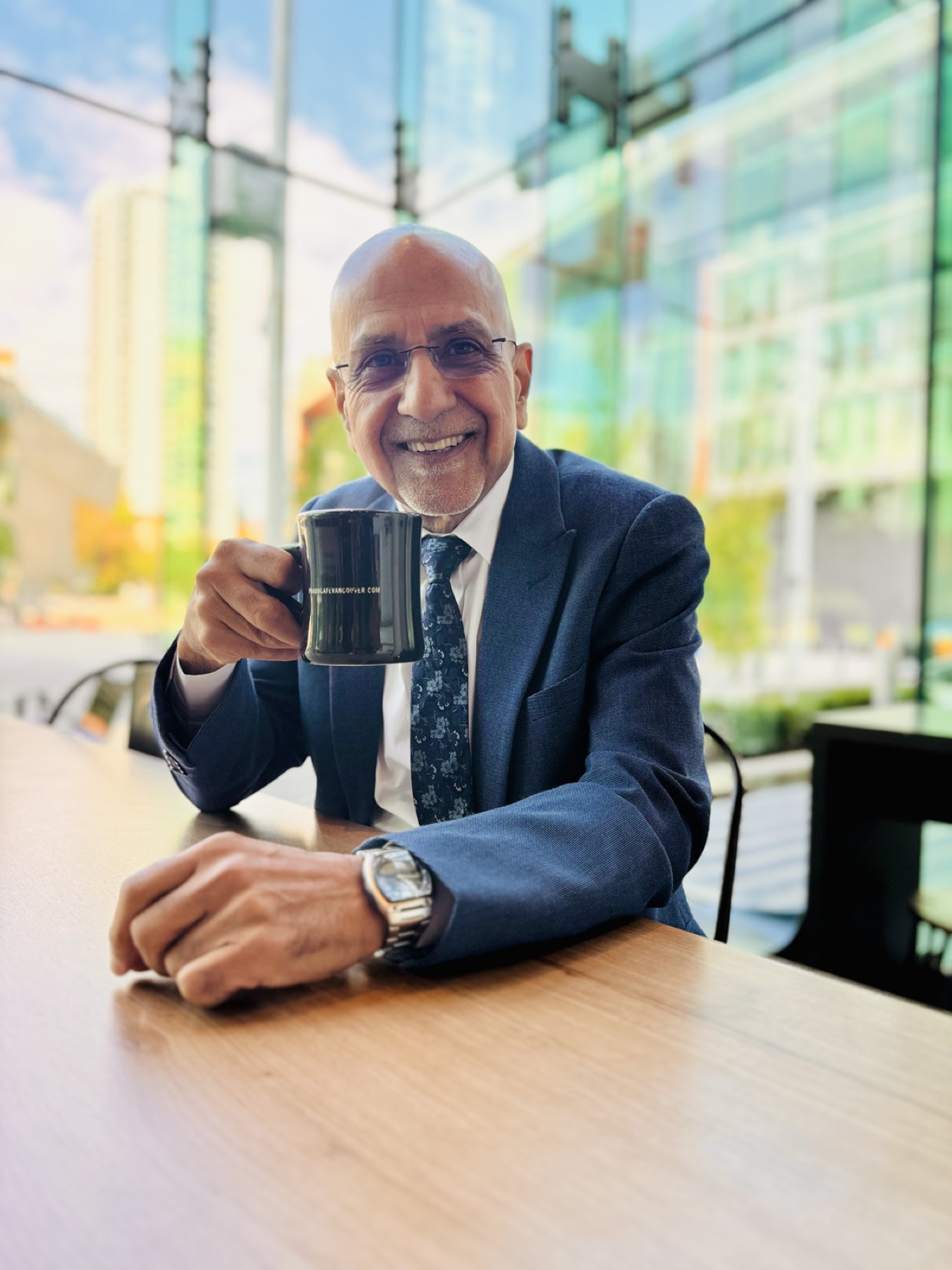Jasbir enjoying coffee at a bright Vancouver café
